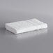 A pack of white Lavex wash cloths on a grey surface.