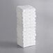 A stack of Lavex white cotton/poly bath mats.