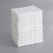 A stack of Lavex white bath towels.