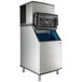 A stainless steel Manitowoc air cooled ice machine with a black and silver Manitowoc logo.