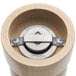 A wooden pepper mill with a metal cap.
