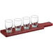 An Acopa mahogany wood flight paddle with Barbary tasting glasses on it.