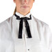 A woman wearing a white shirt and a black Henry Segal adjustable band Kentucky bow tie.