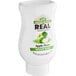 A white plastic bottle of Real Apple Puree Infused Syrup with a green label.