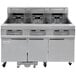 A large commercial electric deep fryer with three drawers.