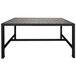 A BFM Seating black metal bolt-down table with a gray wooden top.