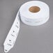 A roll of white paper tickets with a number on it.