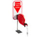 A white and red Take-a-Number sign with a red arrow pointing to a red Turn-O-Matic machine.