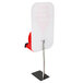 The back of a red Turn-O-Matic sign with white lettering on a metal stand.