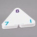 A stack of white triangle-shaped flash cards with numbers on them.