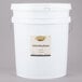 A white bucket with a white label containing Golden Barrel Supreme Baking Molasses.