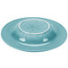 A turquoise bowl with a white edge.