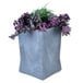 A gunmetal square planter with purple and green plants.
