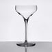A clear Libbey Reserve Coupe Glass with a stem and a rim on a table.
