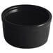 A close-up of a black Acopa stoneware ramekin.