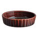 A brown stoneware souffle or creme brulee dish with a ribbed exterior.