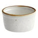 A white stoneware ramekin with brown specks on the rim.