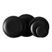 A group of Acopa matte black stoneware coupe plates.