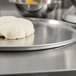 A ball of dough on an American Metalcraft aluminum pizza pan.