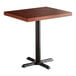 A Lancaster Table & Seating wood butcher block table with a mahogany top and black base plate.