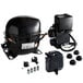 A black air compressor with orange and black wires and a black plastic box.