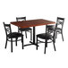 A mahogany Lancaster Table & Seating wood butcher block dining table with black cross back chairs.