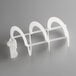 A close-up of a white plastic Narvon auger blade with a clip on it.