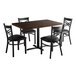 A Lancaster Table & Seating wood butcher block dining table and chairs with black cushions.