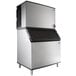 A large silver and black Manitowoc air cooled ice machine.