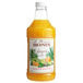 A Monin 1/2 gallon bottle of orange liquid.