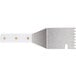 A close-up of a Star metal spatula with a white handle.