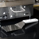 A Star CG-S grooved panini grill spatula on a black counter.