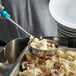a metal pan with a bowl of mashed potatoes