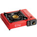 A red Choice portable stove with a brass burner.