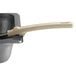 A Vollrath Ivory Perforated Spoodle with a Grip 'N Serve handle in a pan.