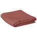A folded mauve rectangular table cover.