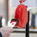 A hand holding a white paper ticket with the number 3.