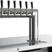 A Beverage-Air black beer dispenser with 12 silver metal beer taps.