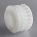 A white plastic gear wheel.