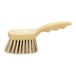 A Carlisle Sparta tan utility/pot scrub brush with a wooden handle.