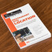 A book titled "Finding Negotiating & Securing the Best Food Service Site for Maximum Profit" on a table.