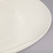 A close up of a Homer Laughlin ivory china plate with a rolled edge.