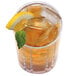 A glass of ice tea with a lemon slice and mint leaf next to a Manitowoc Indigo NXT ice machine.
