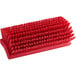 A Carlisle Sparta red floor scrub brush with bristles.