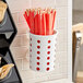 A white Steril-Sil plastic container with red and white flatware inside.