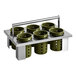 A metal rack with green circular containers holding flatware.