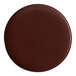 A brown round H. Risch, Inc. leather coaster.