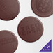 Four brown circular H. Risch, Inc. wine coasters with the words "Taco Casa" in brown.