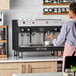An Astra Mega II M2S-017 semi-automatic stainless steel espresso machine on a countertop.