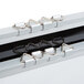 A Chef Master reversible marker board in a metal box with metal clips.